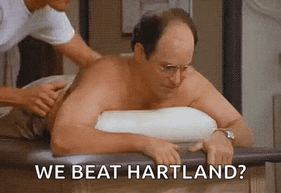 A Shirtless Man Is Sitting On A Table Getting A Massage From A Nurse . GIF
