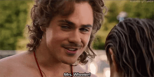 A Shirtless Man Is Smiling And Talking To A Woman While Standing Next To A Pool . GIF