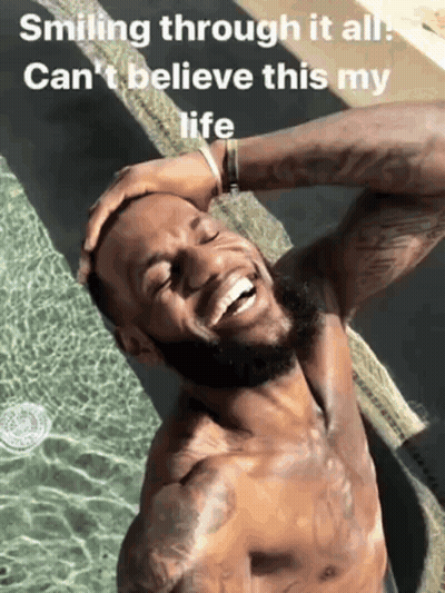 A Shirtless Man Is Smiling In Front Of A Pool With The Words Smiling Through It All Can 'T Believe This My Life GIF