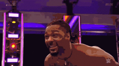 A Shirtless Man Is Smiling In Front Of A Sign That Says 205 Live On It GIF