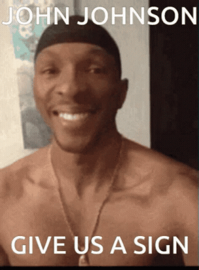 A Shirtless Man Is Smiling In Front Of A Sign That Says John Johnson GIF