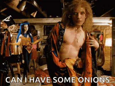A Shirtless Man Is Standing In A Room With The Words " Can I Have Some Onions " On The Bottom GIF