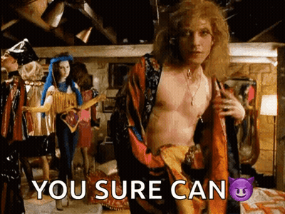 A Shirtless Man Is Standing In A Room With The Words You Sure Can Written On The Bottom GIF