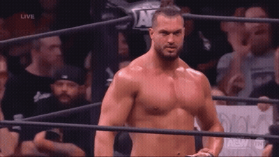 A Shirtless Man Is Standing In A Wrestling Ring . GIF
