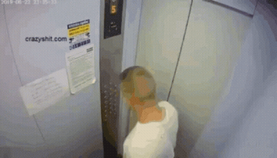 A Shirtless Man Is Standing In An Elevator With A Sign That Says Crazyshit.com On It GIF