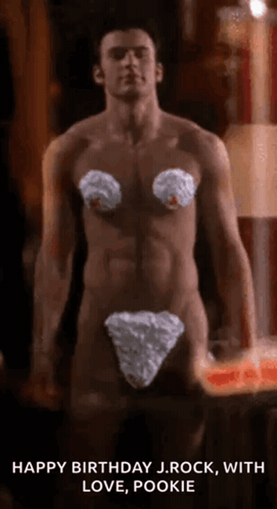 A Shirtless Man Is Standing In Front Of A Candle While Wearing A White Underwear . GIF