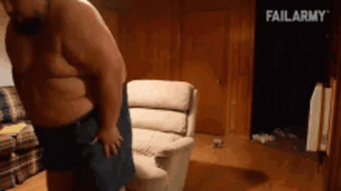 A Shirtless Man Is Standing In Front Of A Couch With Failarmy Written In The Background GIF
