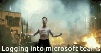 A Shirtless Man Is Standing In Front Of A Fire With The Words Logging Into Microsoft Teams GIF