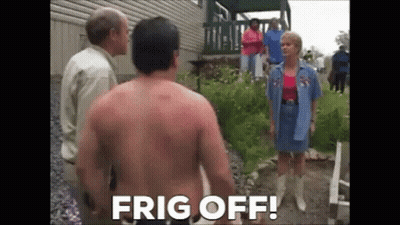 A Shirtless Man Is Standing In Front Of A Group Of People And A Woman . GIF