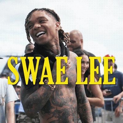 A Shirtless Man Is Standing In Front Of A Sign That Says Swaelee GIF