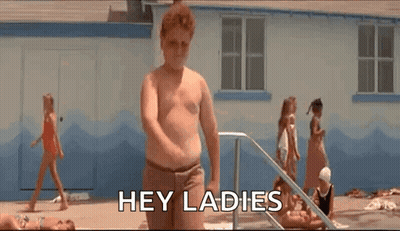 A Shirtless Man Is Standing In Front Of A Swimming Pool And Says `` Hey Ladies '' . GIF