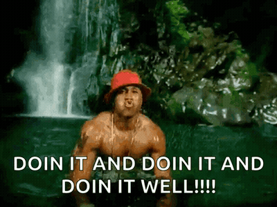 A Shirtless Man Is Standing In Front Of A Waterfall With The Words Doin It And Doin It And Doin It Well !!! GIF