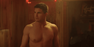 A Shirtless Man Is Standing In Front Of A Wooden Wall And Says What GIF
