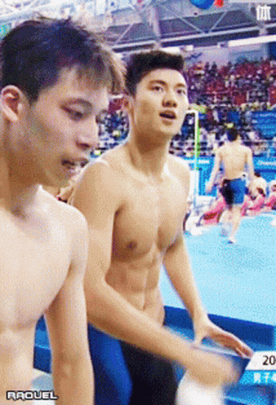 A Shirtless Man Is Standing Next To Another Shirtless Man With The Year 2014 On The Bottom Right GIF
