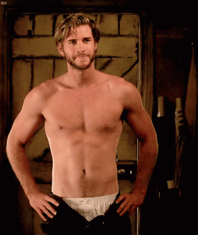 A Shirtless Man Is Standing With His Hands On His Hips In Front Of A Door With The Letters Bw On It GIF