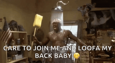 A Shirtless Man Is Taking A Shower And Holding A Yellow Sponge .. GIF