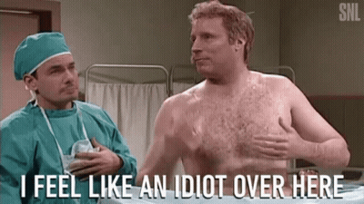 A Shirtless Man Is Talking To A Surgeon In An Operating Room And Says " I Feel Like An Idiot Over Here " . GIF