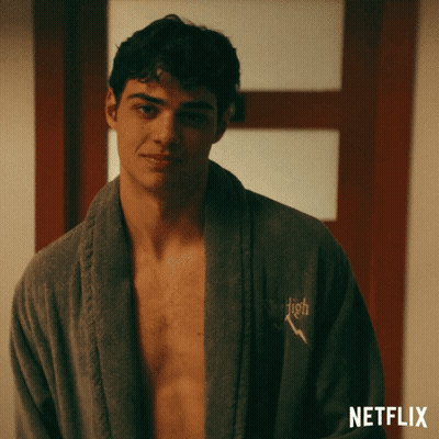 A Shirtless Man Is Wearing A Robe With The Word High Embroidered On It GIF