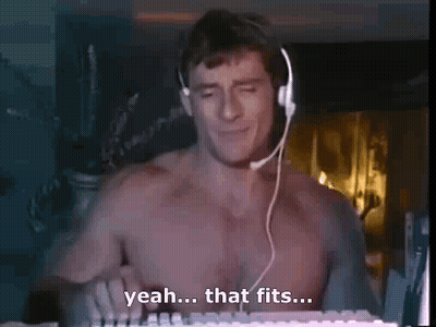 A Shirtless Man Is Wearing Headphones And Playing A Keyboard . GIF