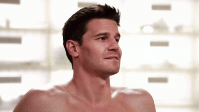 A Shirtless Man Looks At The Camera With A Serious Look On His Face GIF