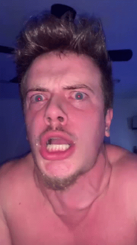 A Shirtless Man Making A Funny Face With His Mouth Open . GIF