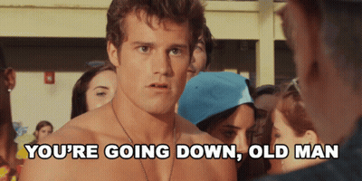 A Shirtless Man Says You 'Re Going Down Old Man In Front Of A Crowd Of People GIF