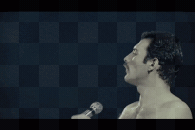A Shirtless Man Singing Into A Microphone With The Word Pressure Written Below Him GIF