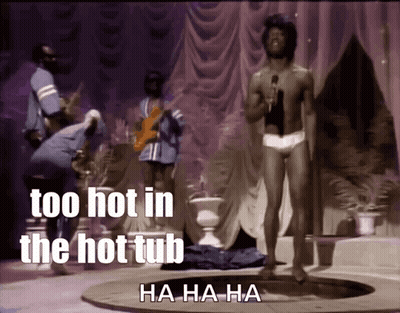 A Shirtless Man Singing Into A Microphone With The Words Too Hot In The Hot Tub GIF
