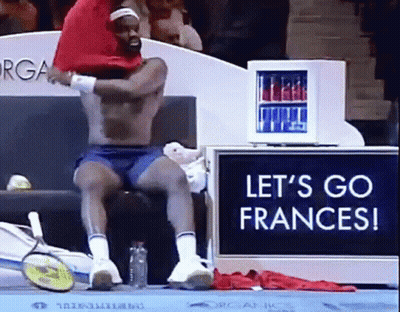 A Shirtless Man Sits In Front Of A Sign That Says " Let 'S Go Frances " GIF