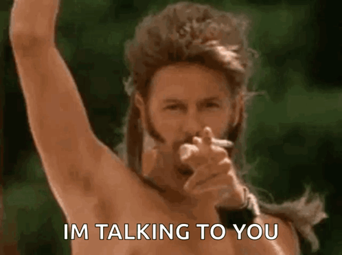 A Shirtless Man Smoking A Cigarette And Pointing At The Camera With The Words Im Talking To You Below Him GIF