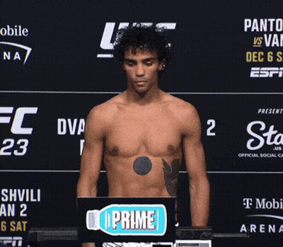 A Shirtless Man Standing In Front Of A Sign That Says Prime GIF