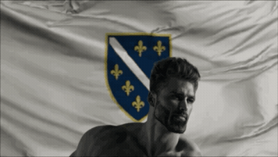A Shirtless Man Stands In Front Of A Flag With The Coat Of Arms On It GIF