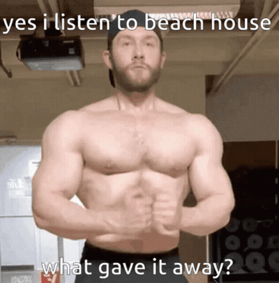 A Shirtless Man Stands In Front Of A Projector With The Caption " Yes I Listen To Beach House What Gave It Away " On The GIF