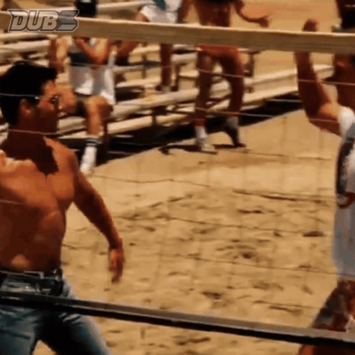 A Shirtless Man Stands In Front Of A Volleyball Net With Dubs Written On The Bottom GIF