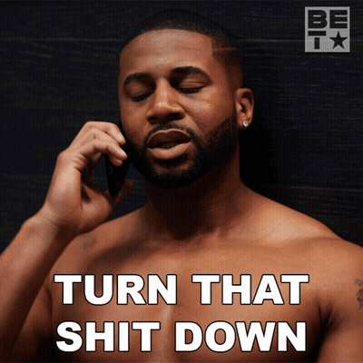 A Shirtless Man Talking On A Cell Phone With The Words Turn That Shit Down GIF