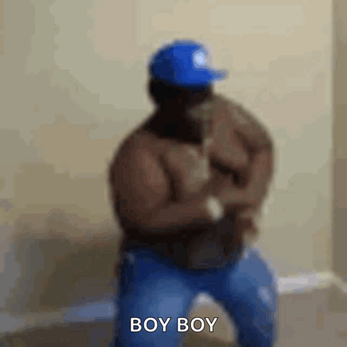 A Shirtless Man Wearing A Blue Hat Is Dancing And Says Boy Boy . GIF