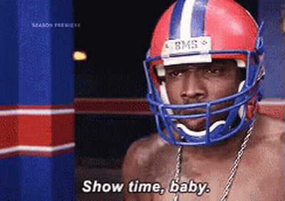 A Shirtless Man Wearing A Football Helmet Says " Show Time Baby " GIF