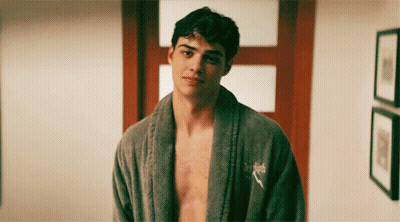 A Shirtless Man Wearing A Grey Robe With A Puma Logo On His Chest GIF