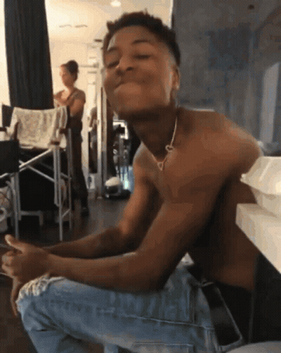 A Shirtless Man Wearing A Heart Shaped Necklace GIF
