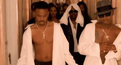 A Shirtless Man Wearing A Necklace That Says X On It GIF
