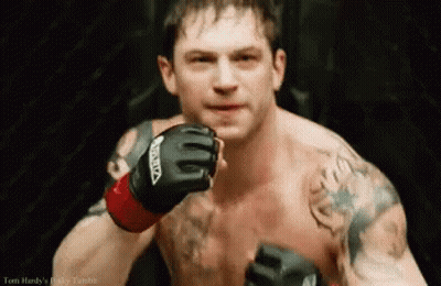 A Shirtless Man Wearing A Pair Of Boxing Gloves With The Word Venum On Them GIF