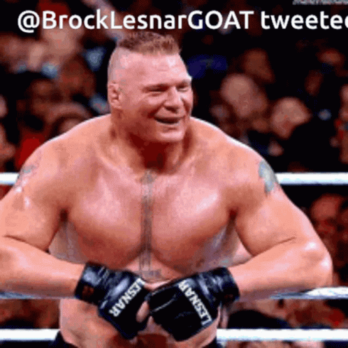 A Shirtless Man Wearing Boxing Gloves With Lesnar On Them GIF