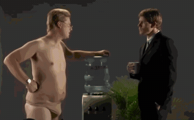 A Shirtless Man Wearing Glasses Is Making A Funny Face GIF