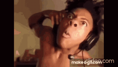 A Shirtless Man Wearing Headphones And A Microphone . GIF