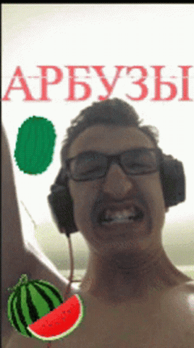 A Shirtless Man Wearing Headphones With A Watermelon In Front Of Him GIF