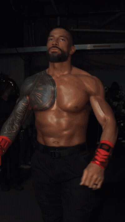 A Shirtless Man Wearing Red Boxing Gloves And Black Pants GIF