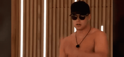 A Shirtless Man Wearing Sunglasses And A Baseball Cap . GIF