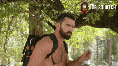 A Shirtless Man With A Backpack Stands Under A Tree With Dr. Squatch Written On The Bottom GIF