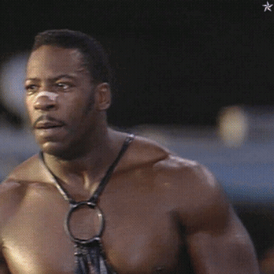 A Shirtless Man With A Bandage On His Nose Looks To The Side GIF