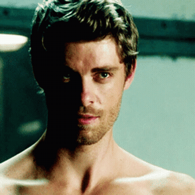 A Shirtless Man With A Beard And A Shadow On His Face GIF